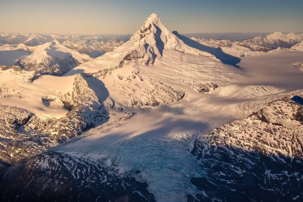 Golden hour aerial of Mount aspiring with a glacier flowing down in front