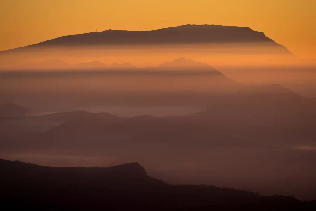 Telephoto photo of Mount William at sunrise with layers of mountains ridges below