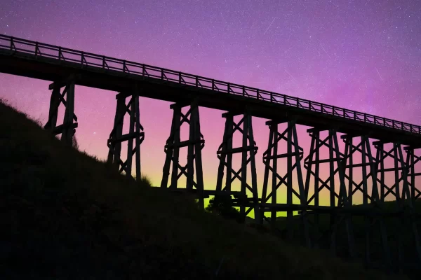 Aurora Australis at Nimmons Bridge Ballarat with purple and green hues and satellites overhead