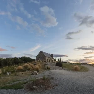 Sunset over a small stone church in Teakpo surrounded by tussocks and pine trees