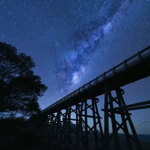 Simmons Bridge trestle bridge at night with the Milky Way core rising behind it