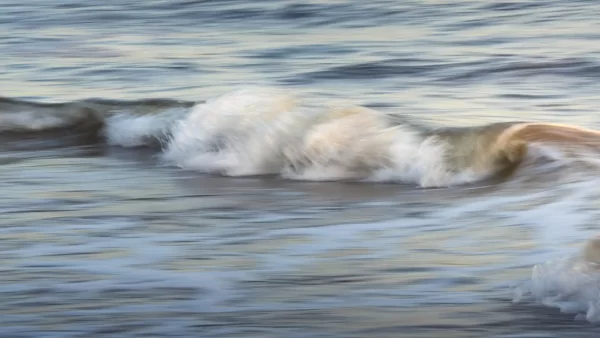 Long exposure photo of waves crashing on the beach