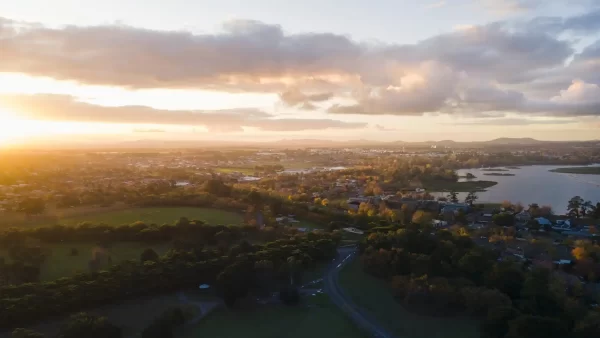 Aerial view of Ballarat West at Sunset with golden light and lake Wendouree and mountains in the distance