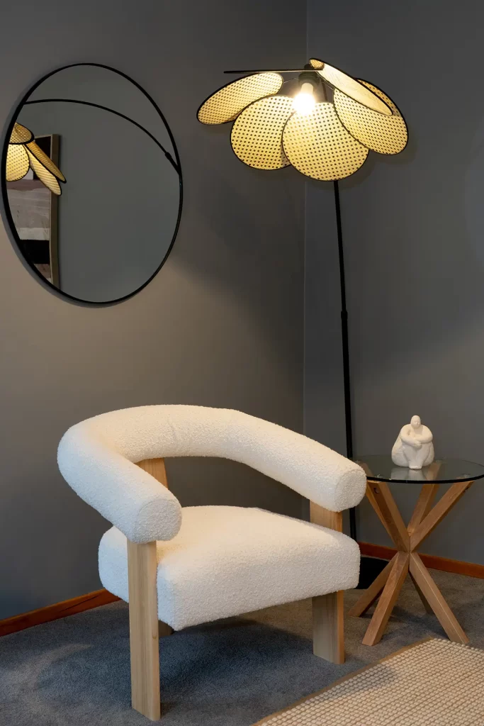 Real estate photo of a chair and floral lamp in a dark lounge